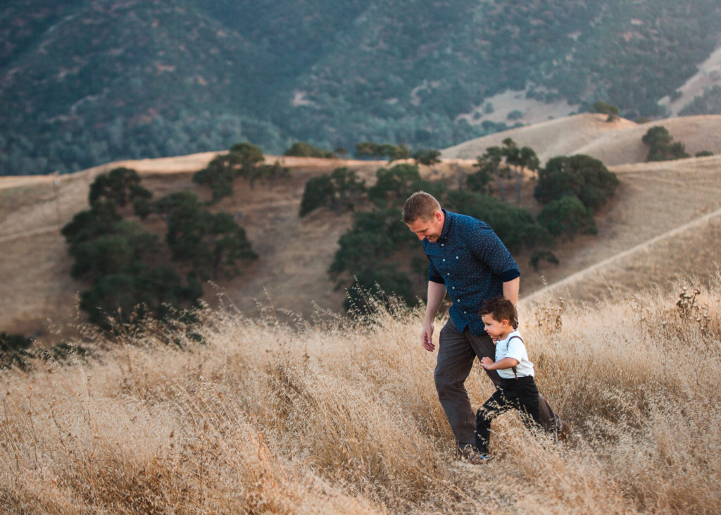 Father and son walk through the Livermore Hills during Golden Hour family photo session