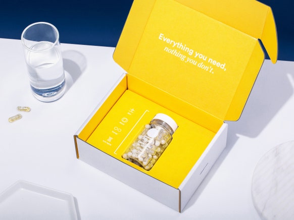 Image of Ritual pre-natal vitamins in premium packaging with glass of water.